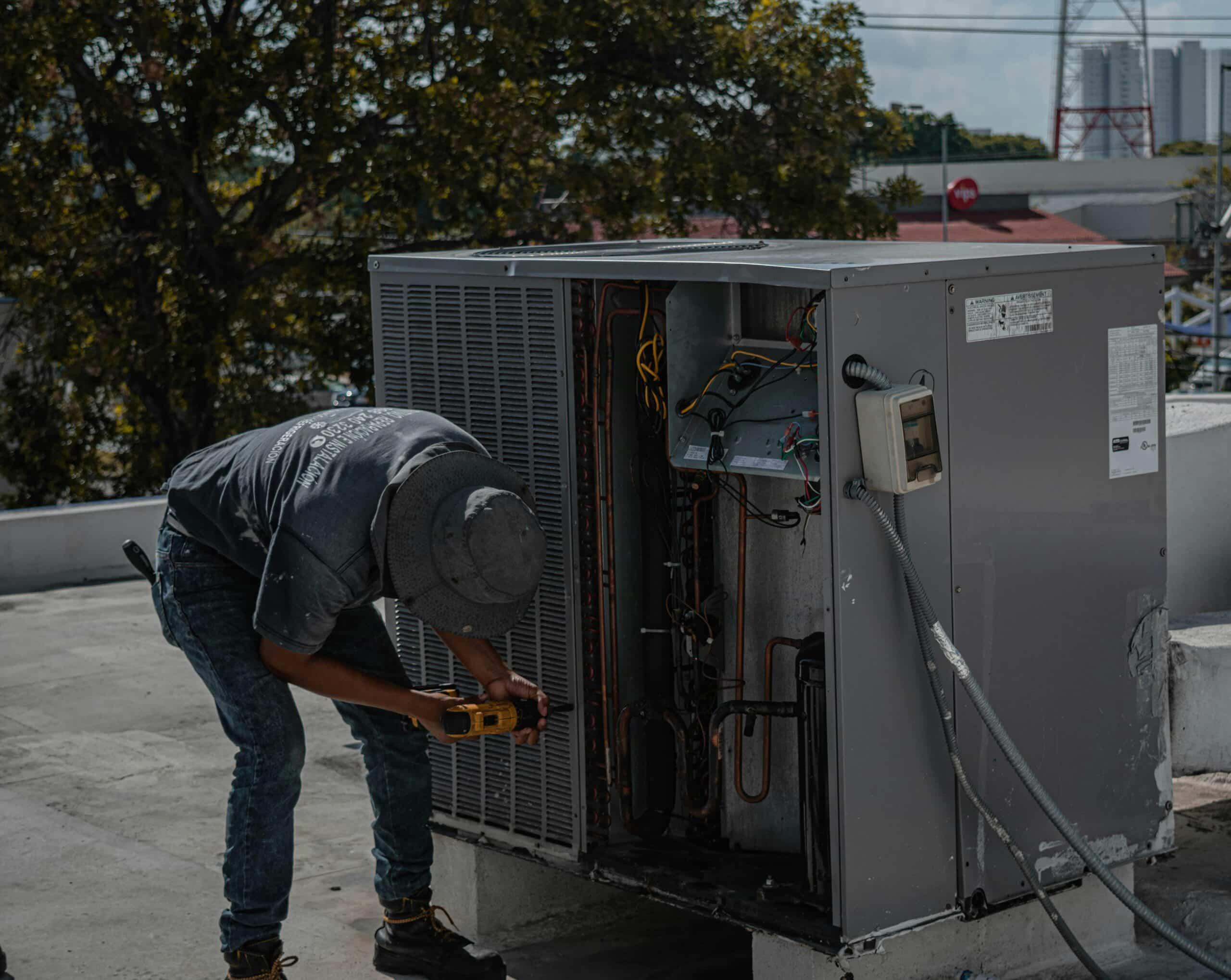 HVAC Technician working on an HVAC unit outside.